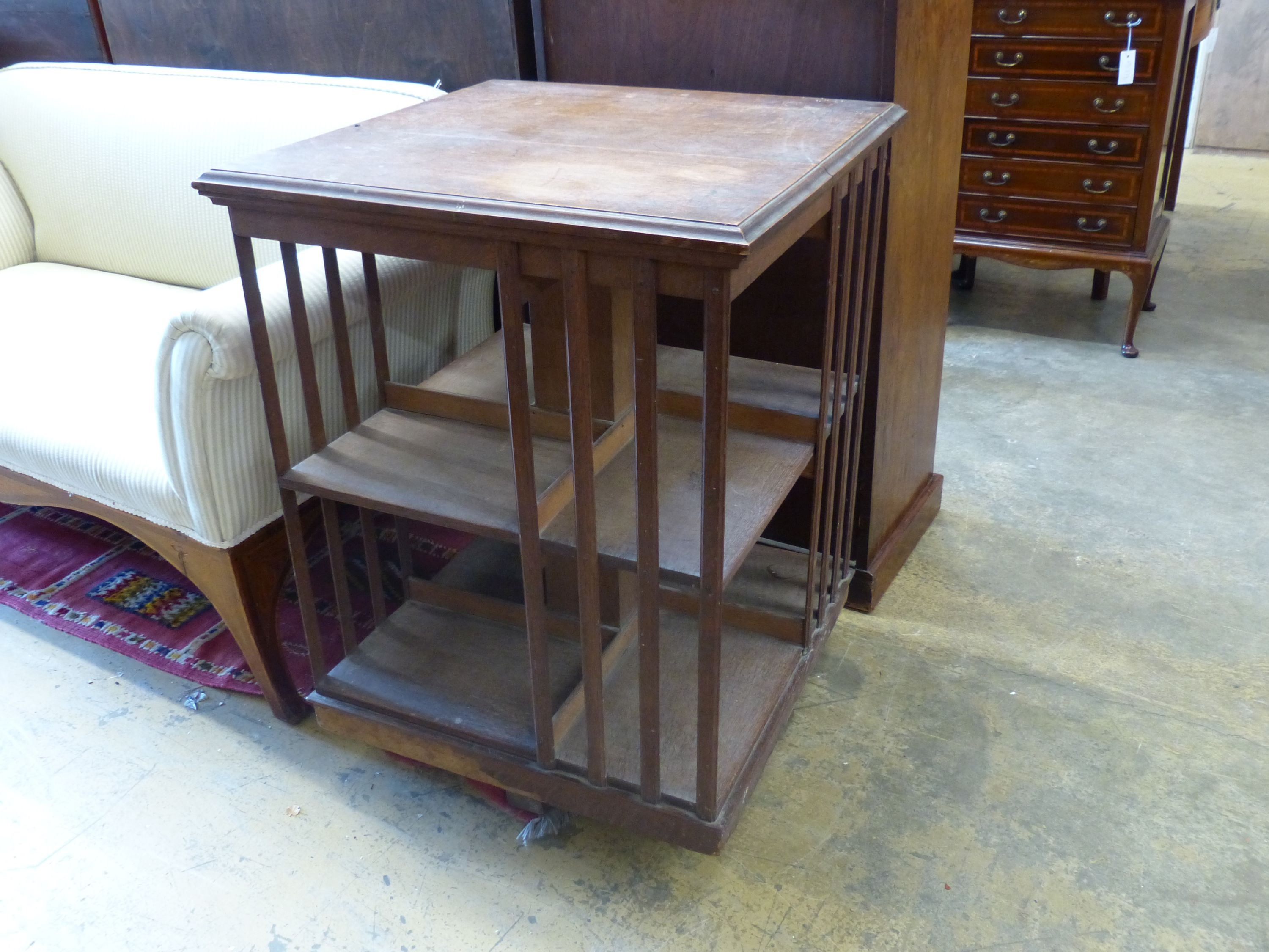 An early 20th century oak revolving bookcase, length 63cm, depth 63cm, height 86cm